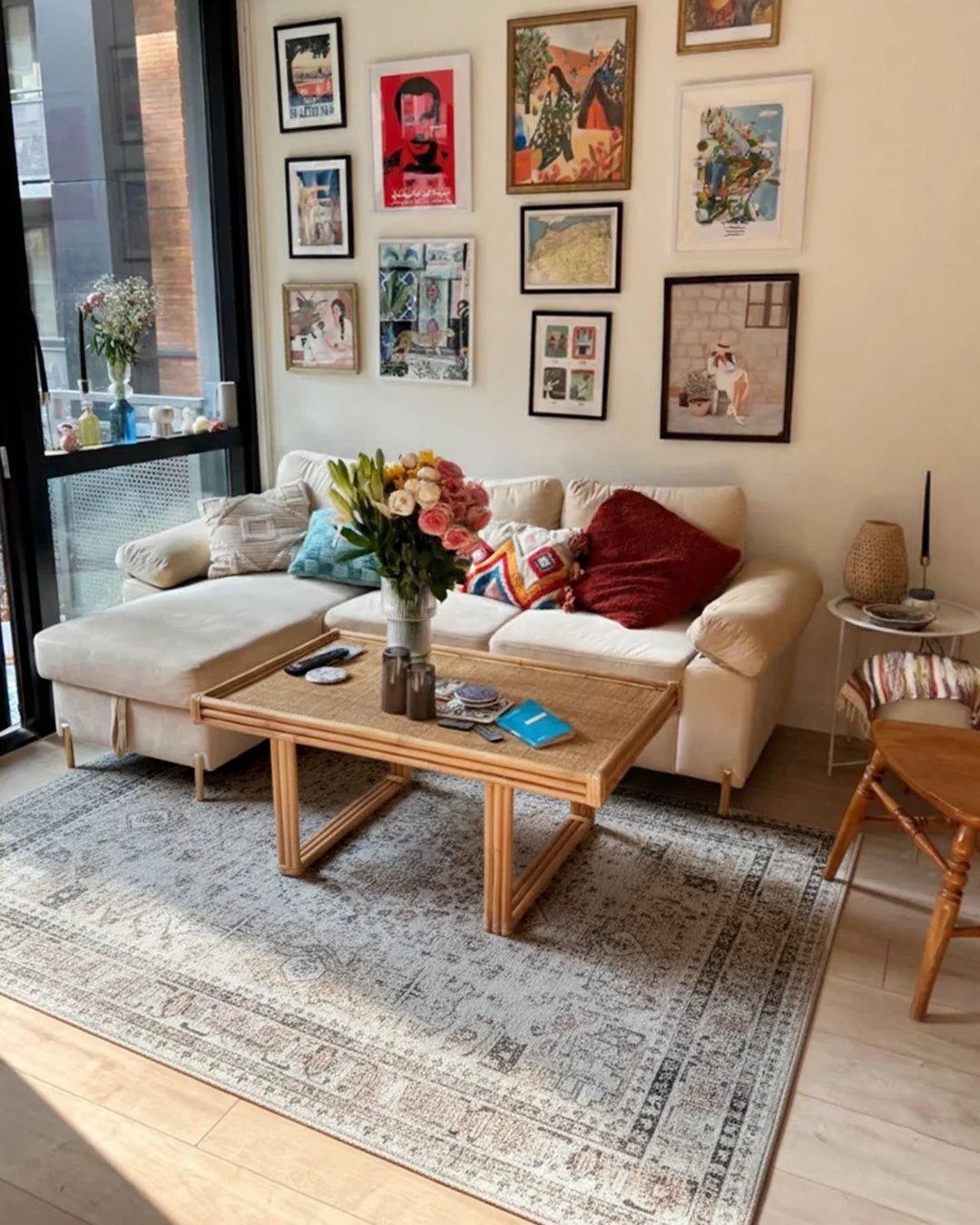 Living room with a beige sofa, wooden coffee table, and wall art.