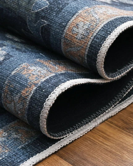 Roll of blue patterned rug on a wooden floor