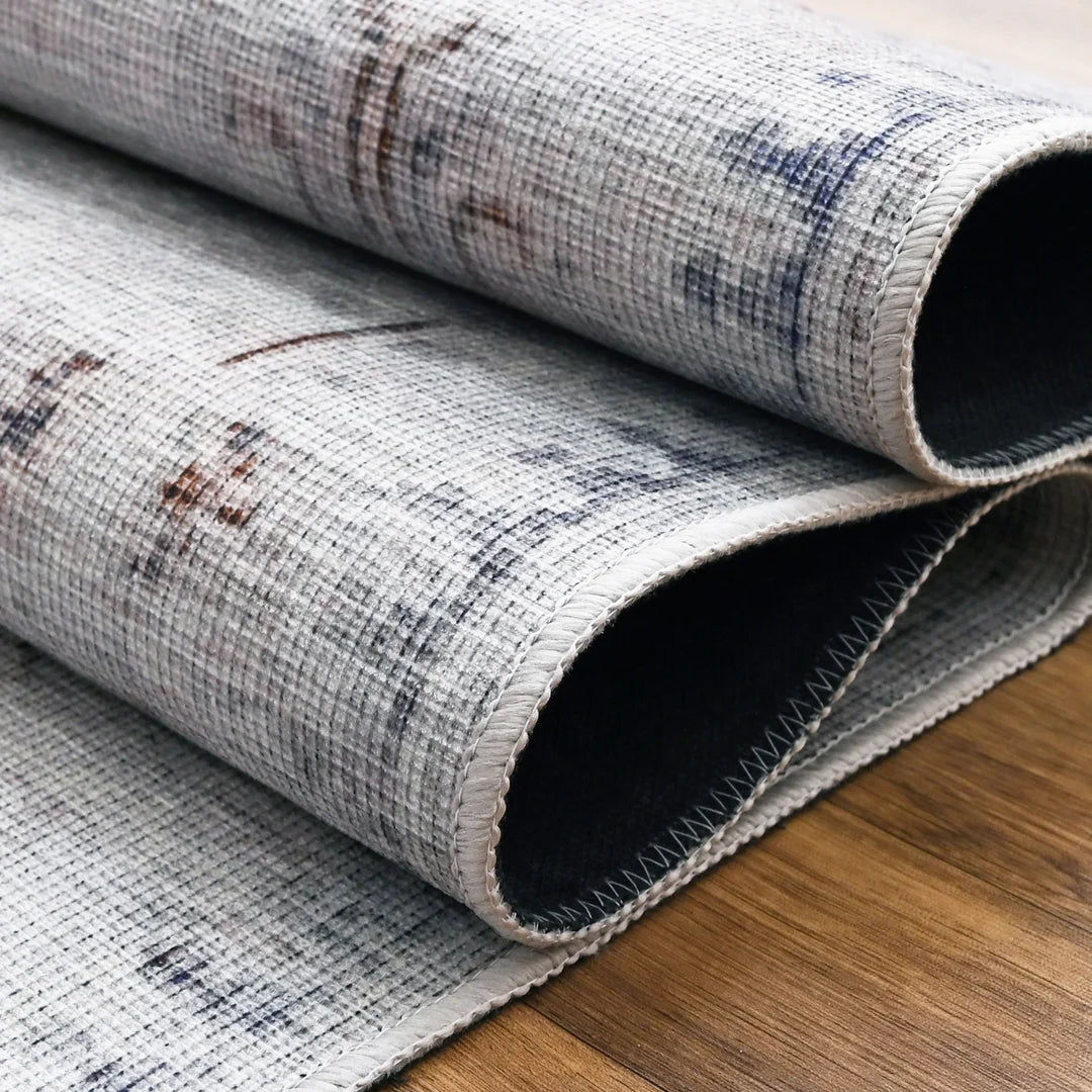 Rolled-up rug with a textured pattern on a wooden floor