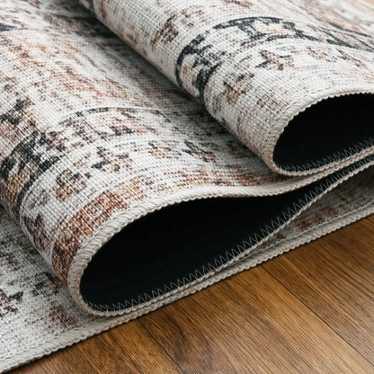 Roll of patterned rug on a wooden floor