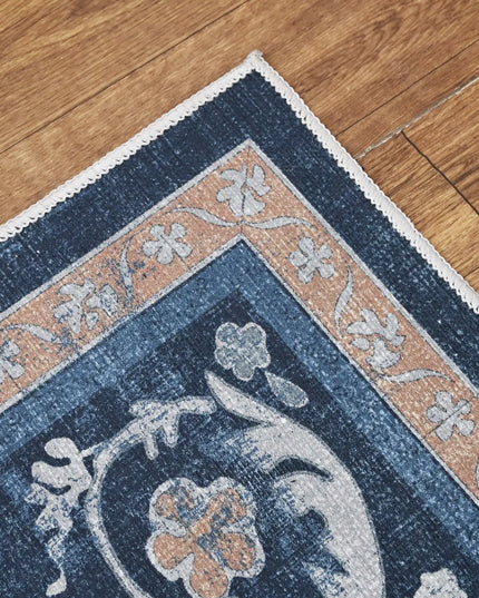 Close-up of a blue floral patterned rug on a wooden floor
