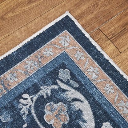 Close-up of a blue floral patterned rug on a wooden floor