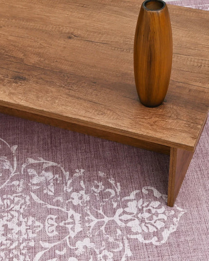 Wooden table with a vase on a patterned rug