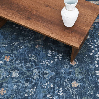 Wooden table with a white vase on a blue patterned rug