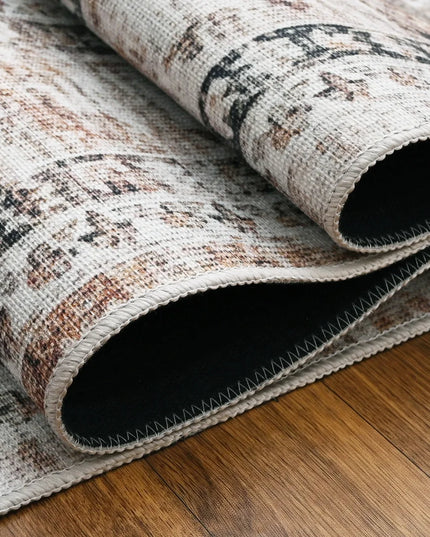 Roll of patterned rug on a wooden floor