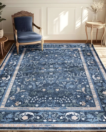 Blue patterned rug in a room with a chair and side tables.