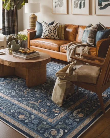 Cozy living room with brown leather sofa, wooden coffee table, and decorative rug.