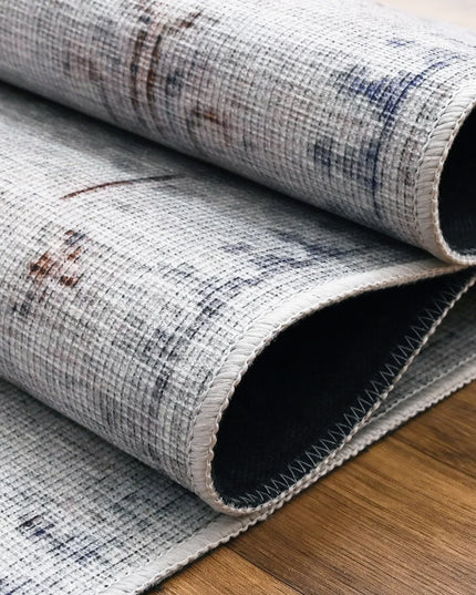 Rolled-up rug with a textured pattern on a wooden floor