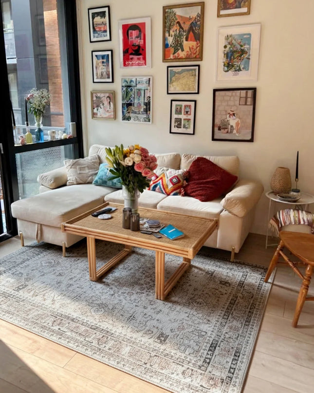 Living room with a beige sofa, wooden coffee table, and wall art.