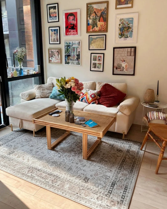Living room with a beige sofa, wooden coffee table, and wall art.